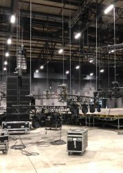 Installation of professional sound, light, video and stage equipment for a concert. Lifting truss and flight cases with cables.